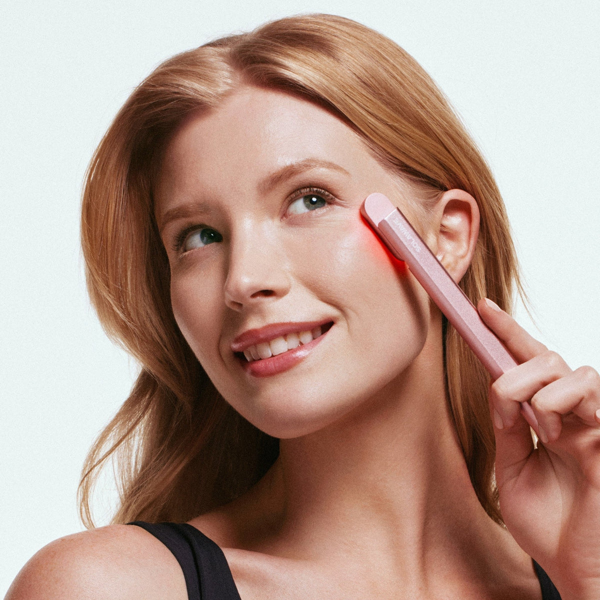 woman using solawave light therapy tool