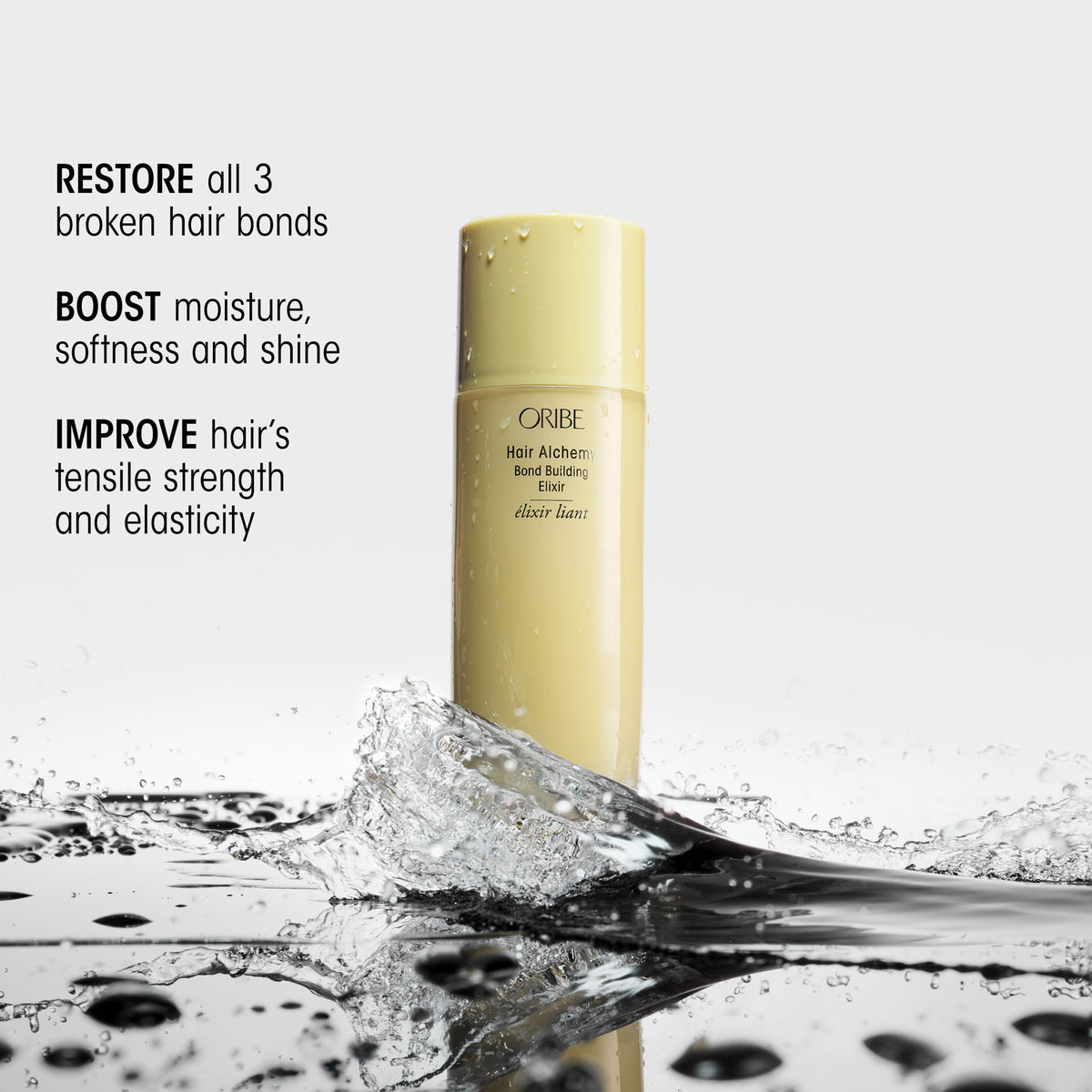 A pale yellow bottle of Oribe Hair Alchemy Bond Repair Leave-In Treatment stands in a splash of water, with text listing benefits for restoring bonds, boosting moisture, and improving strength.