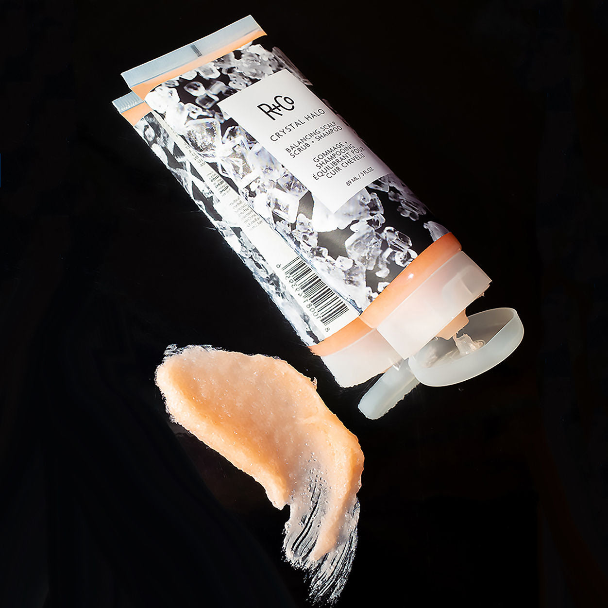 Lifestyle image of R+Co Crystal Halo Balancing Scalp Scrub and Shampoo