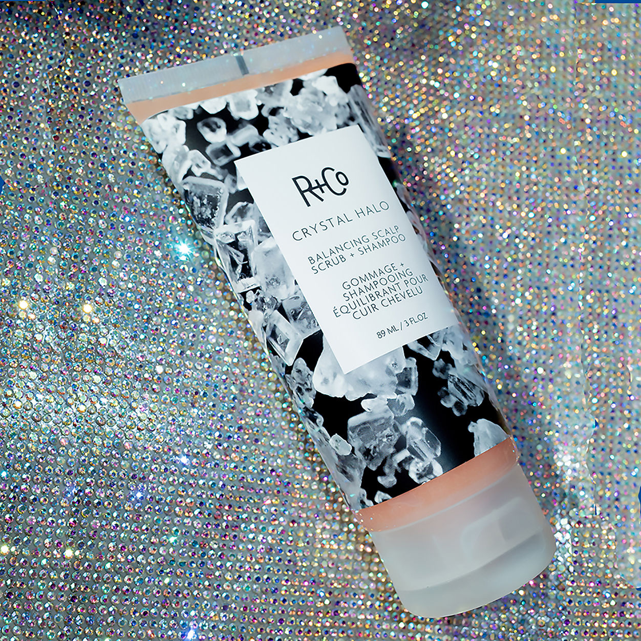 Lifestyle image of R+Co Crystal Halo Balancing Scalp Scrub and Shampoo