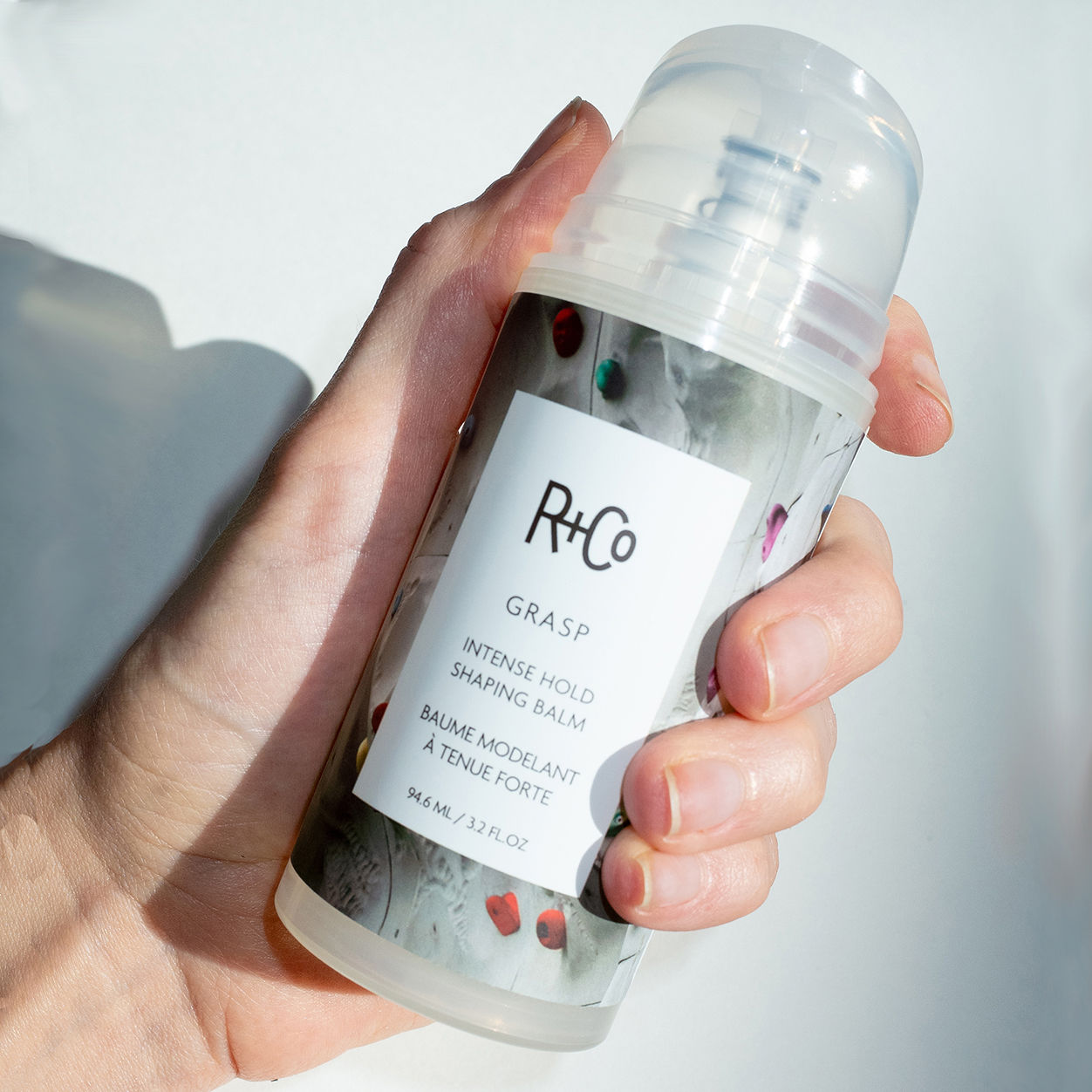 Lifestyle image of R+Co Grasp Intense Hold Shaping Balm