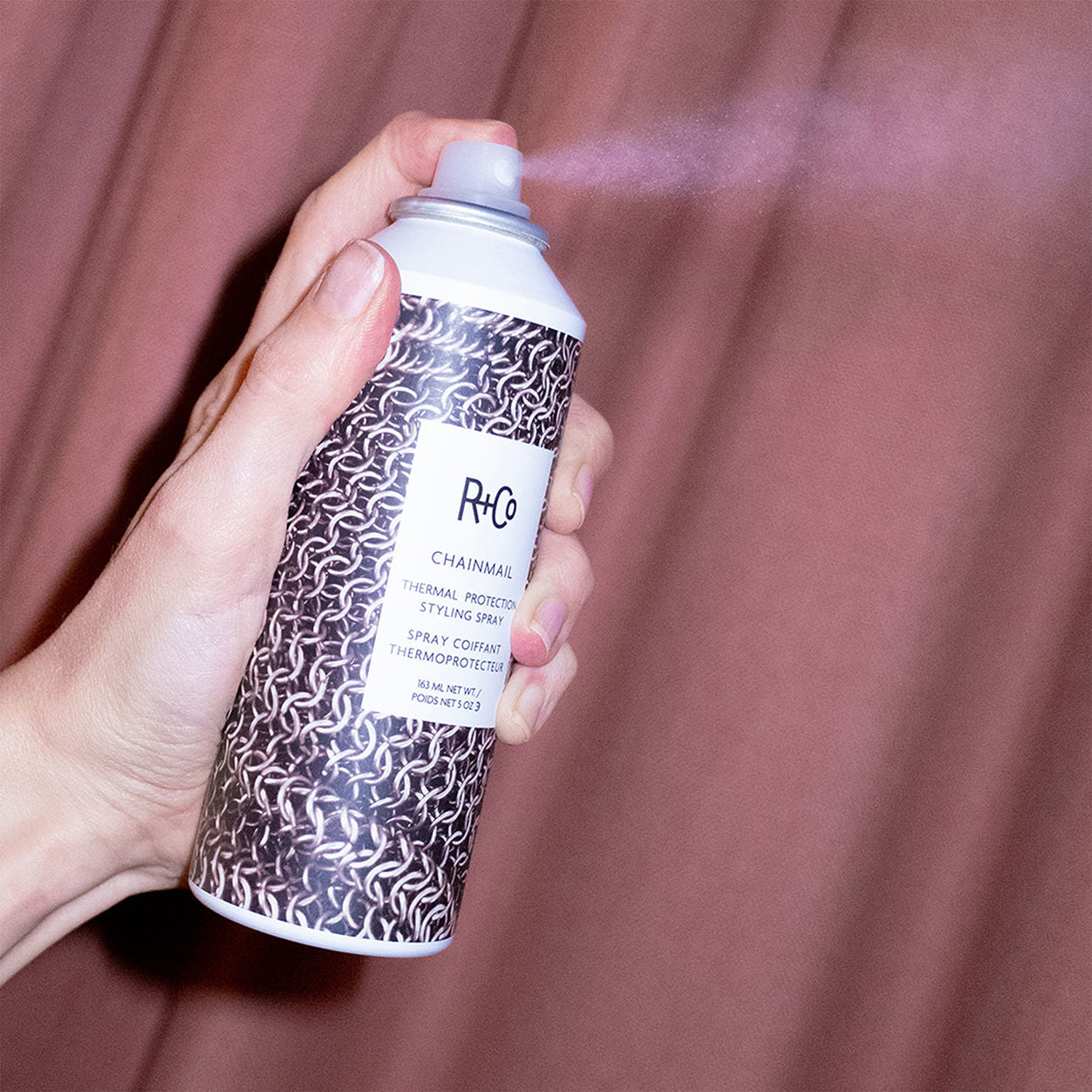 Lifestyle image of R+Co Chainmail Thermal Protection Styling Spray