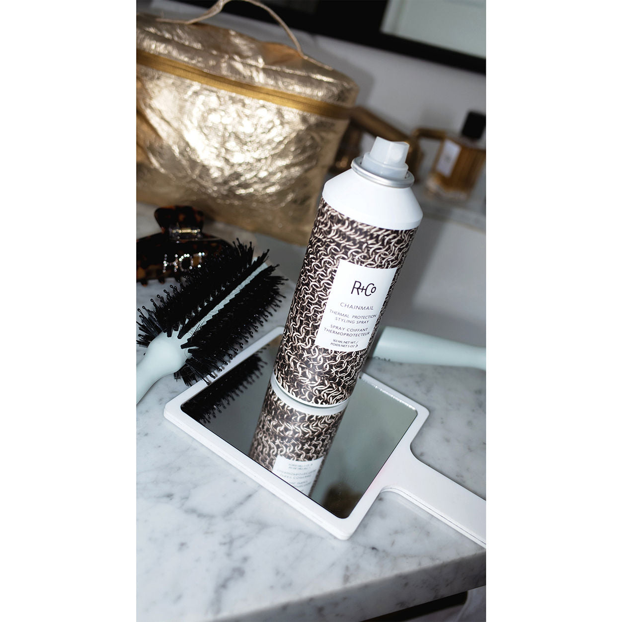 Lifestyle image of R+Co Chainmail Thermal Protection Styling Spray
