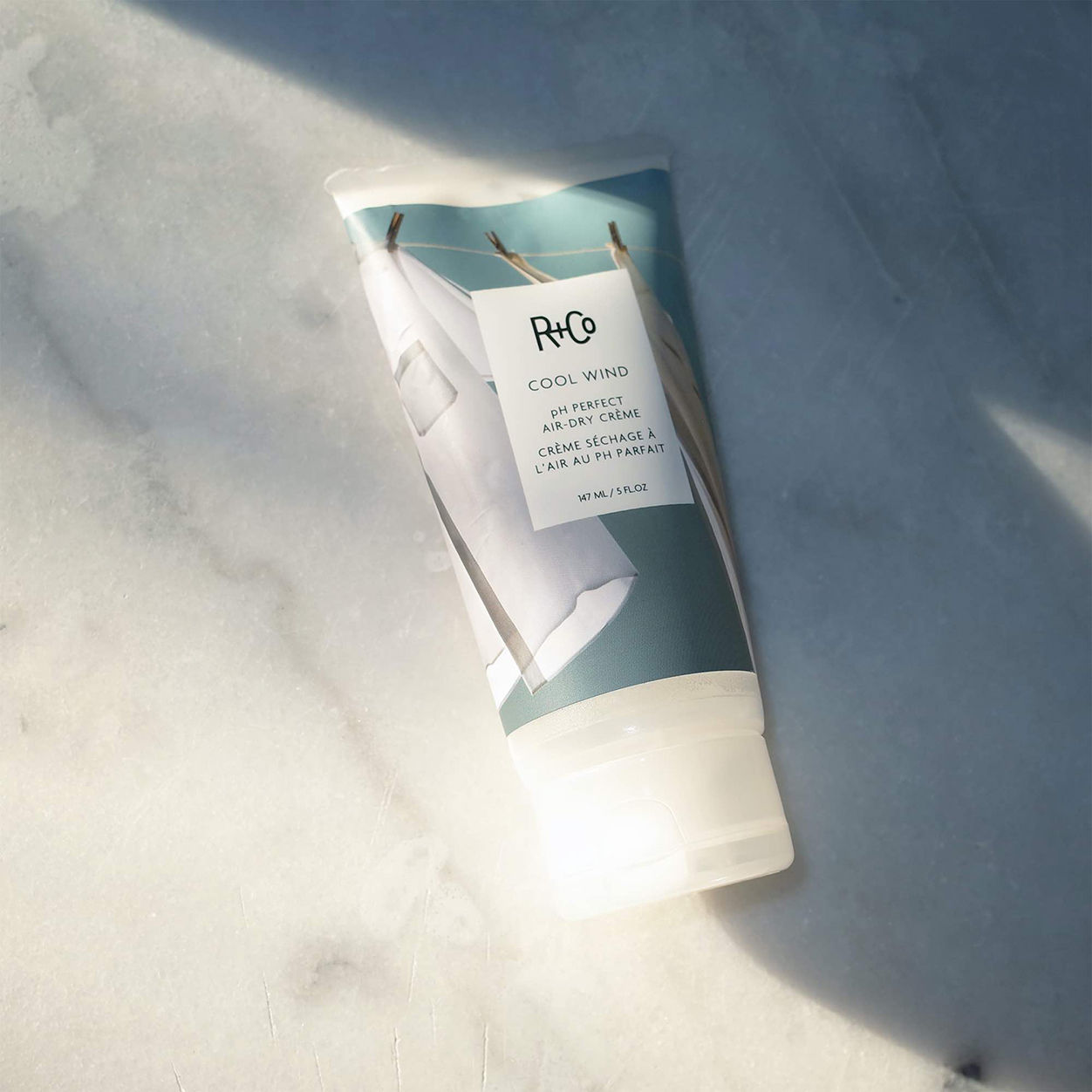 Lifestyle image of R+Co Cool Wind Air Dry Creme