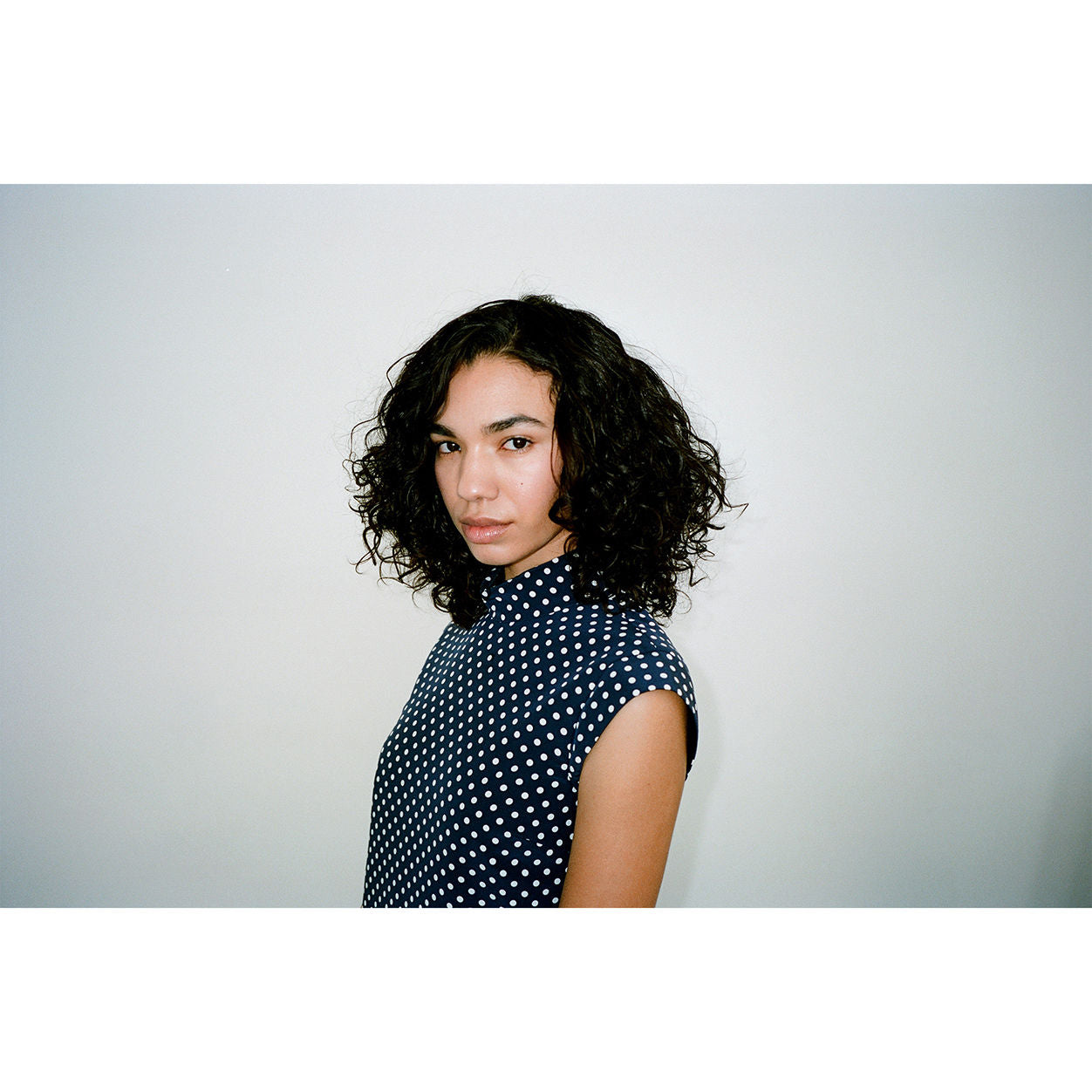 Model image of R+Co Cassette Curl Shampoo and Superseed Oil Complex