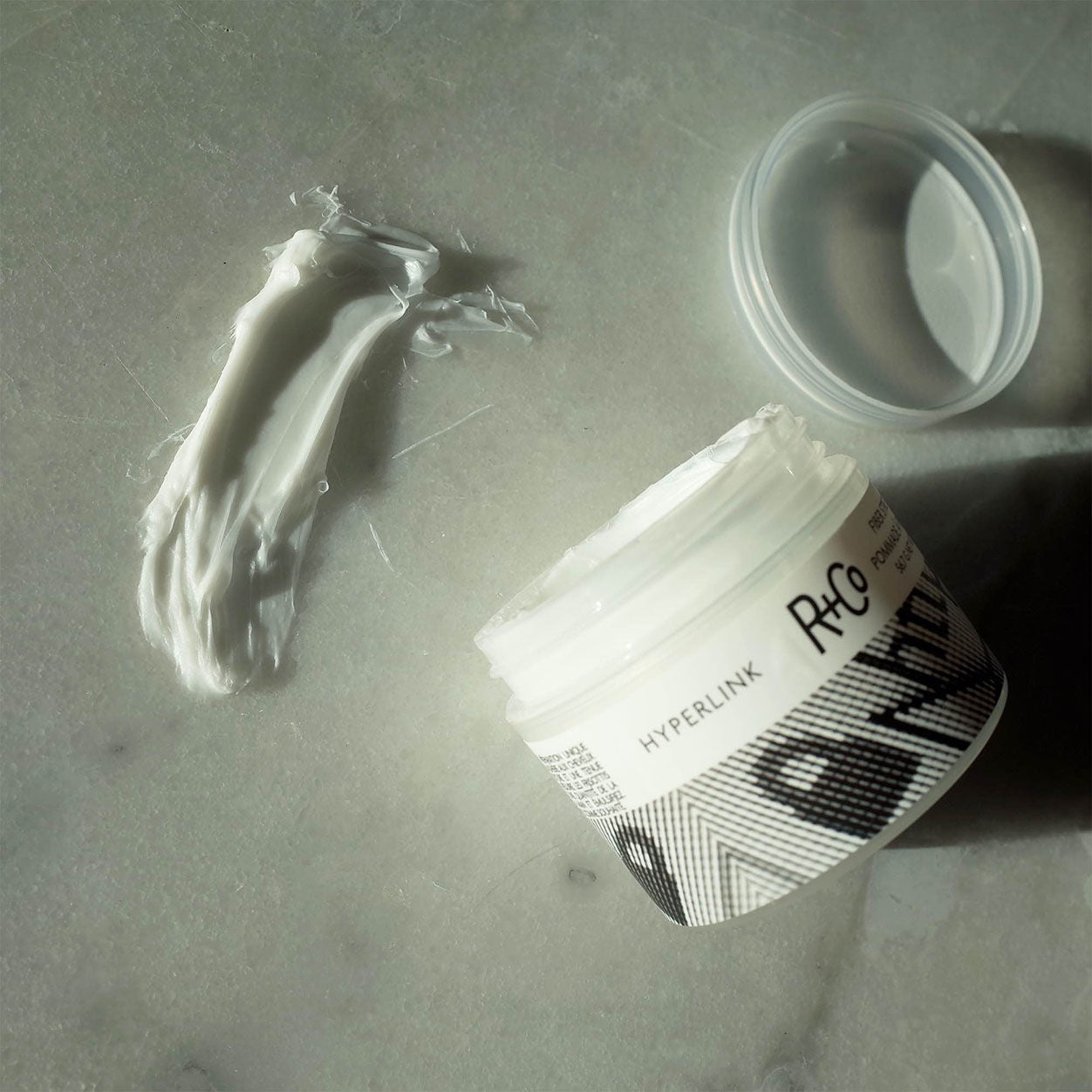 Lifestyle image of R+Co Hyperlink Fiber Stretch Pomade
