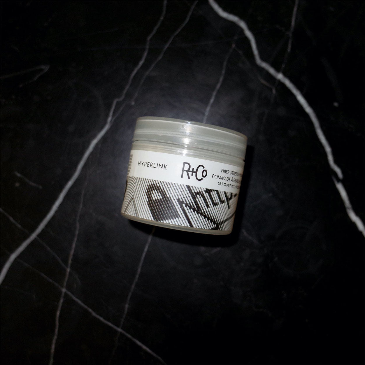 Lifestyle image of R+Co Hyperlink Fiber Stretch Pomade