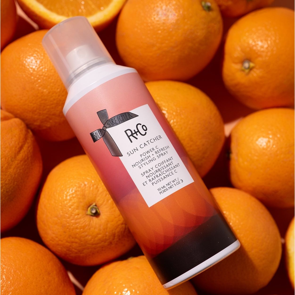 Lifestyle image of R+Co Sun Catcher Power C Nourish and Refresh Styling Spray