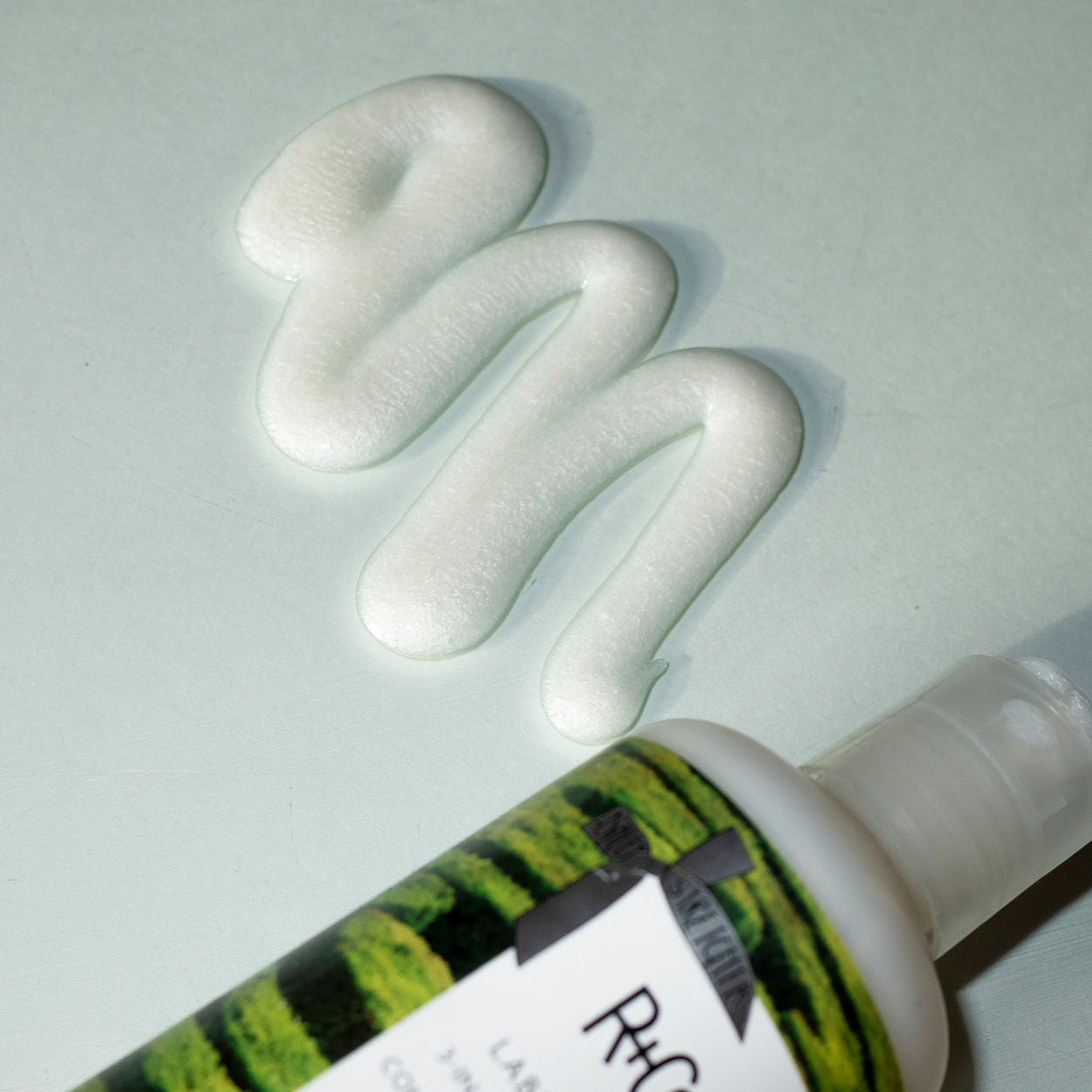 Lifestyle image of R+Co Labyrinth 3-in-1 Texturizing Shampoo and Conditioner and Styler