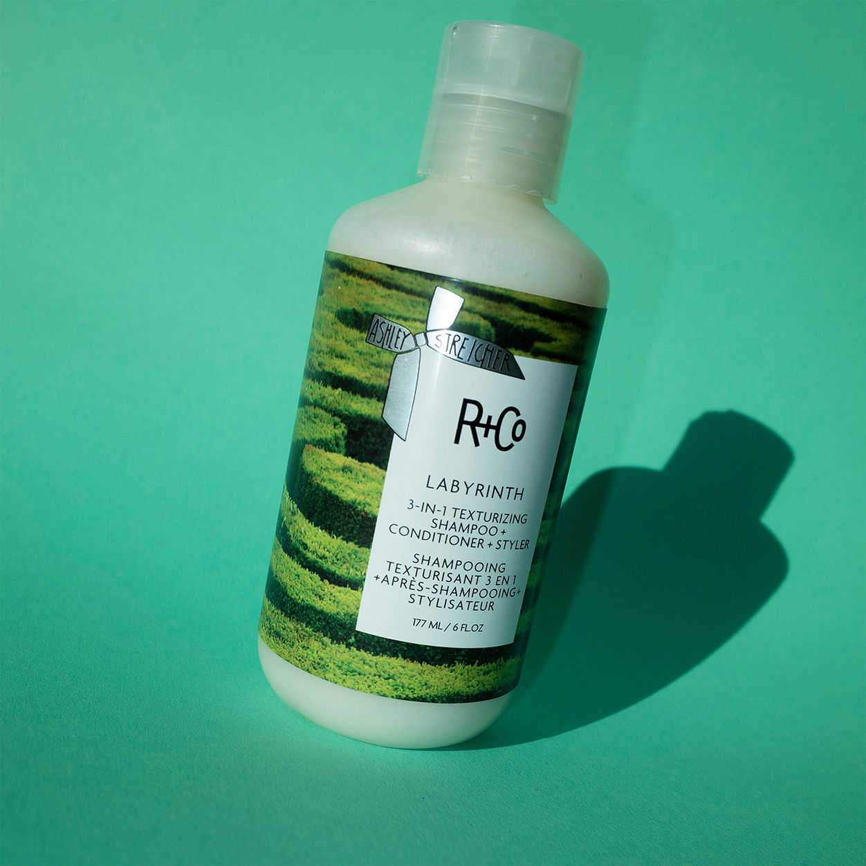 Lifestyle image of R+Co Labyrinth 3-in-1 Texturizing Shampoo and Conditioner and Styler
