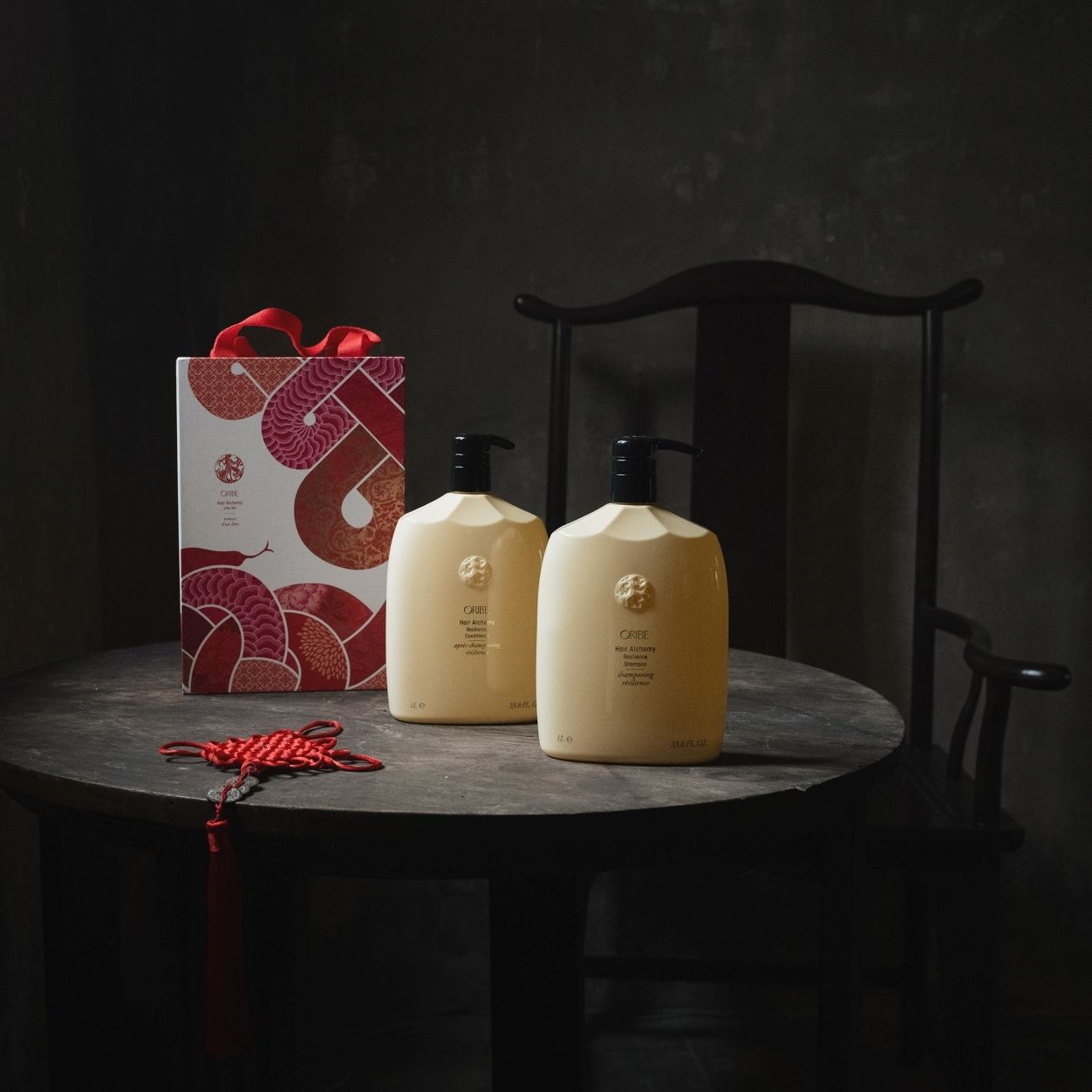 Lifestyle image of Oribe Lunar New Year Hair Alchemy Liter Set (Limited Edition)