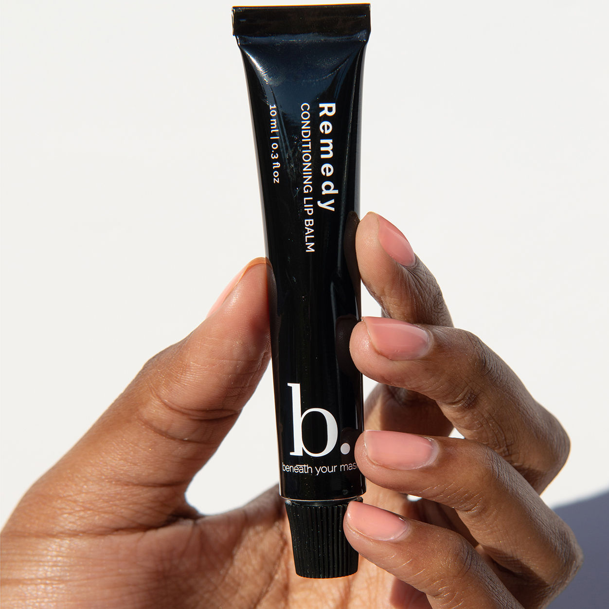 Lifestyle image of Beneath Your Mask Remedy Conditioning Lip Balm