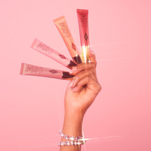 Lifestyle image of Charlotte Tilbury Matte Beauty Blush Wand variant: Pillow Talk Pink Pop
