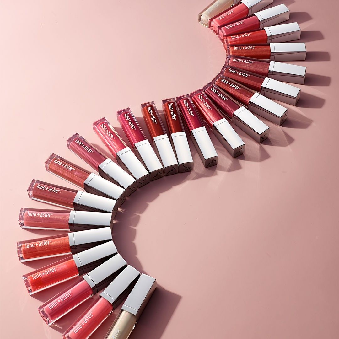 Lifestyle image of Lune+Aster Vitamin C+E Lip Gloss variant: Pomegranate