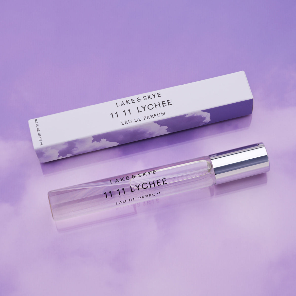 A glass rollerball of 11 11 Lychee Eau de Parfum and its matching rectangular box.