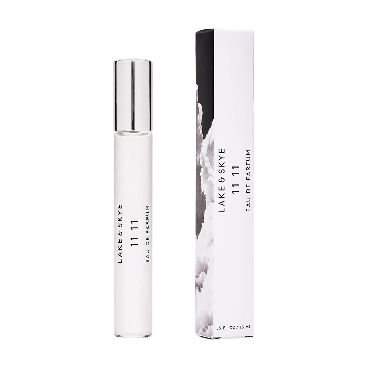 A white Lake & Skye 11 11 Eau de Parfum rollerball bottle and its matching white box decorated with an amber-toned black and white image of clouds.