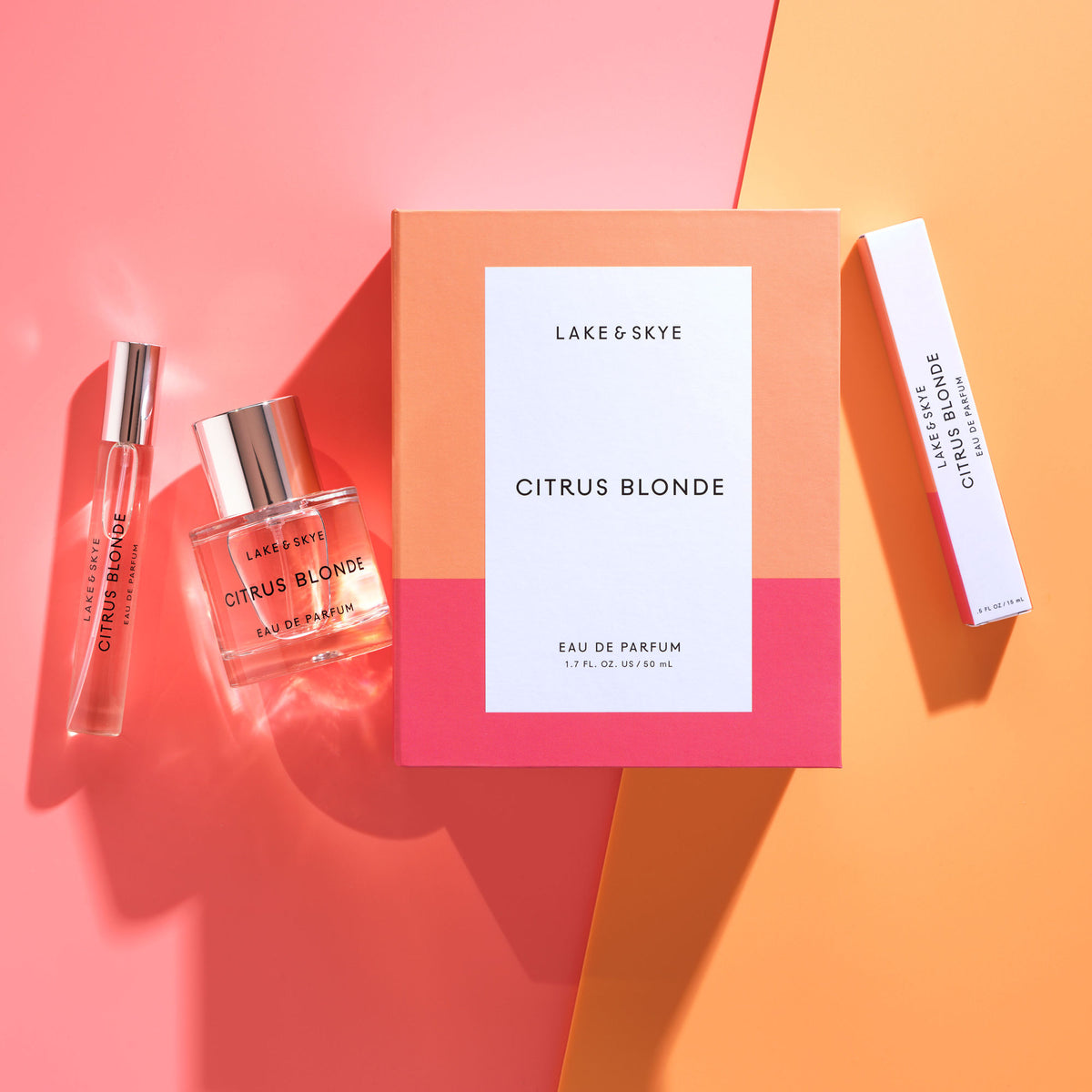 A Citrus Blonde Eau de Parfum gift set consisting of a large square box, a glass bottle, a travel spray, and a slender box, all featuring white labels with black text evocative of cedarwood and peach blossom.