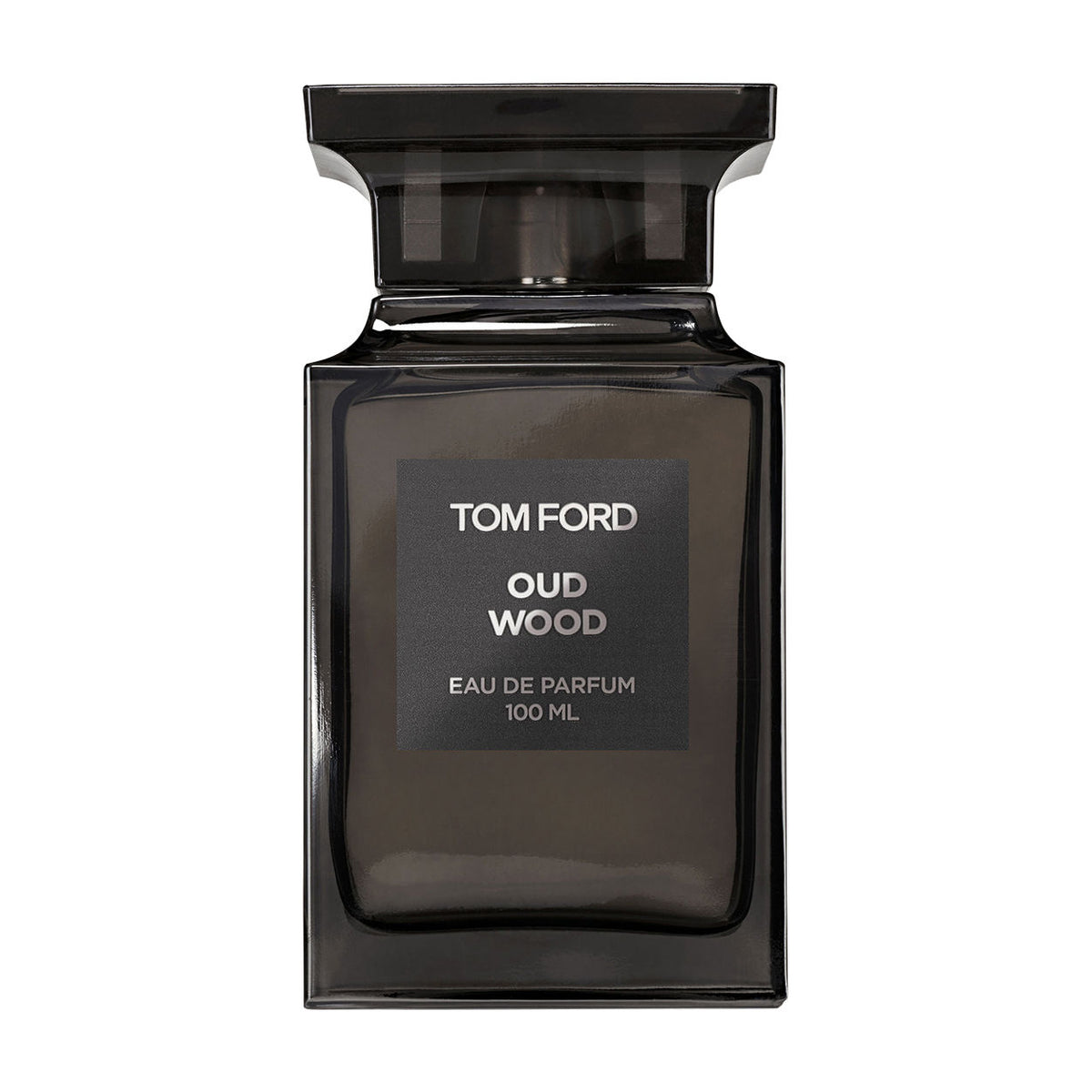 A rectangular, dark-tinted glass bottle of Tom Ford Oud Wood Eau de Parfum Spray, topped with a black cap and featuring a label that highlights its exotic spices and 100 ml volume.