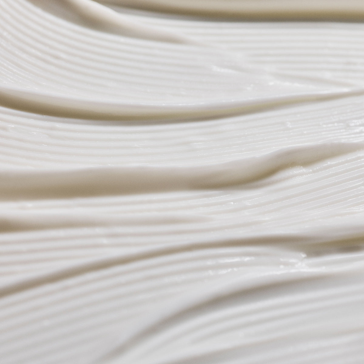 A thick, white Énergie The Cream with smooth, ridged application strokes.