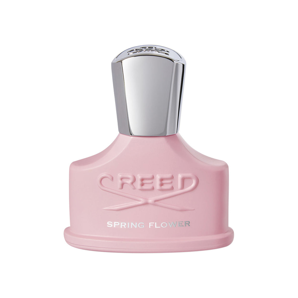 A light pink Creed Spring Flower Eau de Parfum bottle with a silver cap, embossed with text reading CREED and SPRING FLOWER, representing a delicate fragrance.
