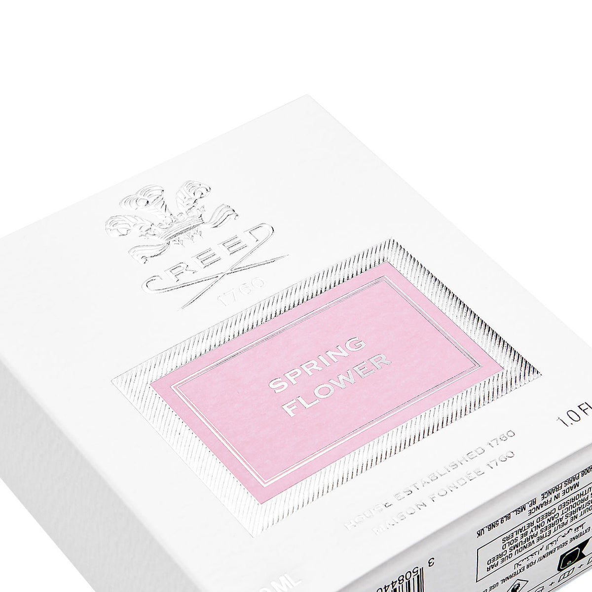 White Creed Spring Flower Eau de Parfum box with a pink label for a delicate fragrance, featuring the product name and an embossed crest above.