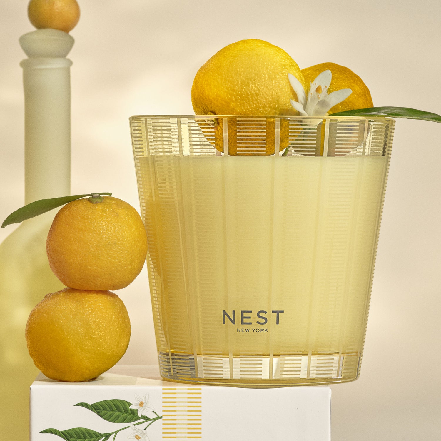 Lifestyle image of Nest Sunlit Yuzu & Neroli Candle variant: 21.1 oz (3-Wick)