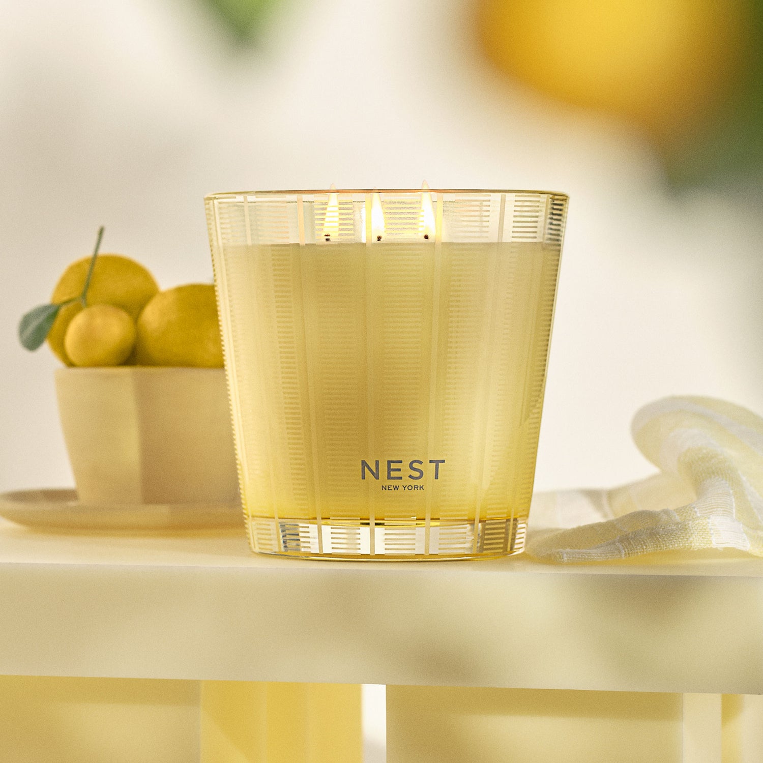 Lifestyle image of Nest Sunlit Yuzu & Neroli Candle variant: 21.1 oz (3-Wick)