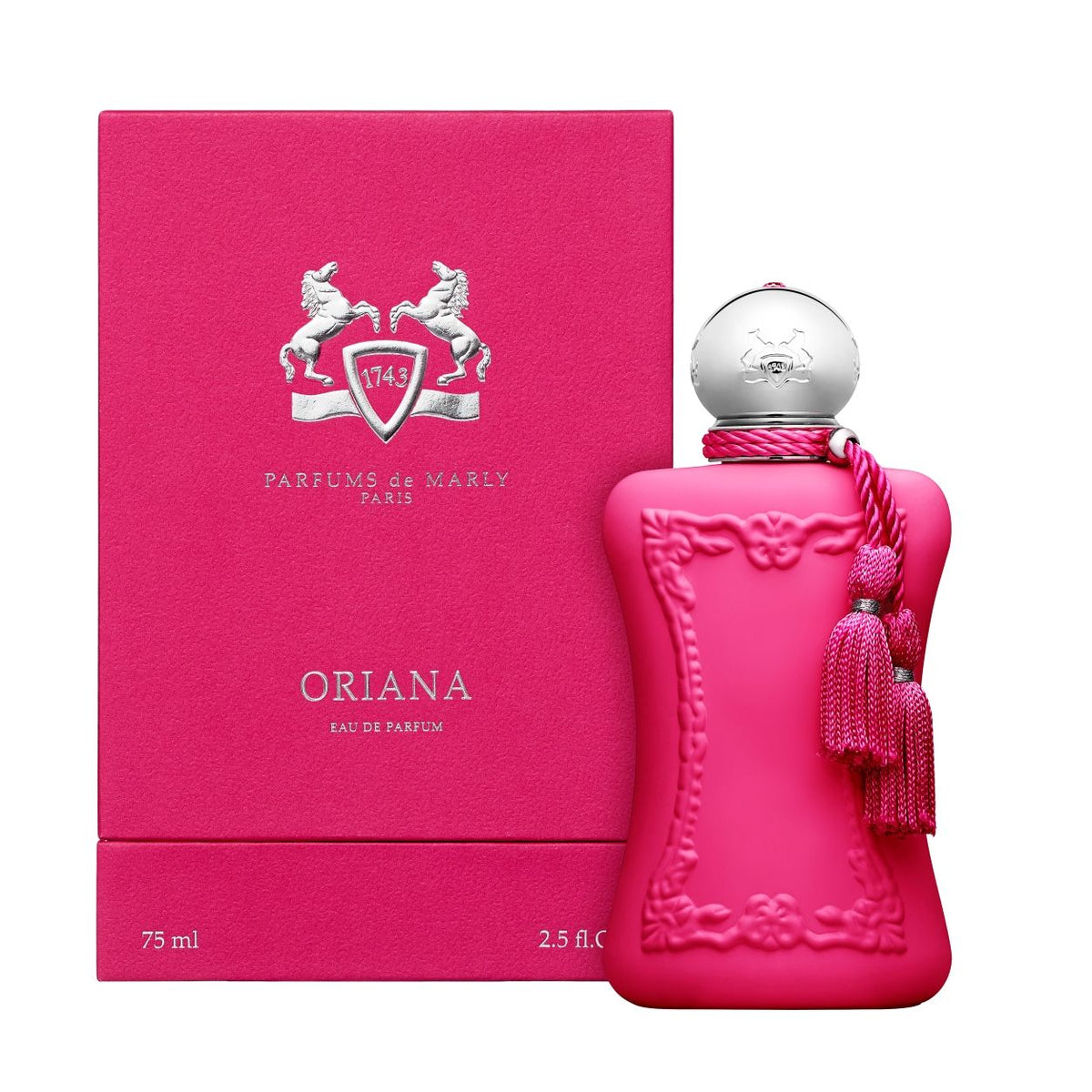 Bright pink Oriana Eau de Parfum bottle with a silver cap and pink tassels, standing next to its matching pink rectangular box.