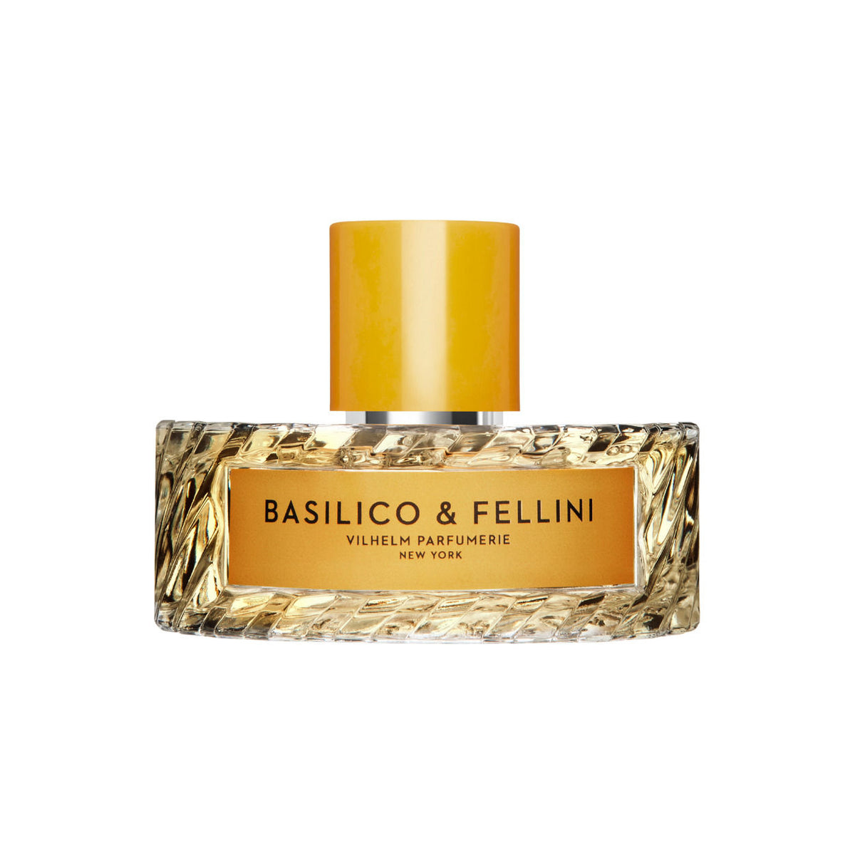 A wide, rectangular bottle of Vilhelm Parfumerie Basilico and Fellini Eau de Parfum with a textured glass base, a gold label reading BASILICO & FELLINI, and a cylindrical yellow cap.