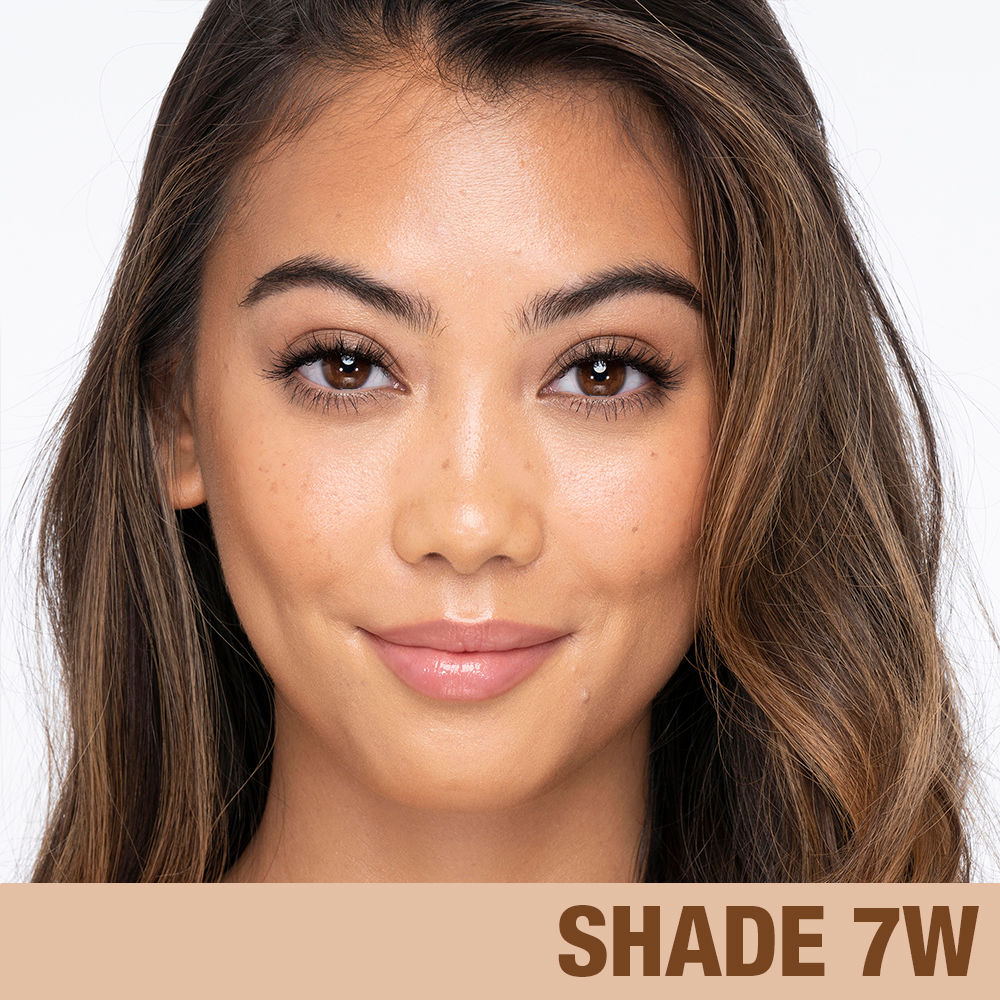 Model image of Charlotte Tilbury Charlotte's Beautiful Skin Foundation variant: 7 Warm (medium with golden yellow undertones)