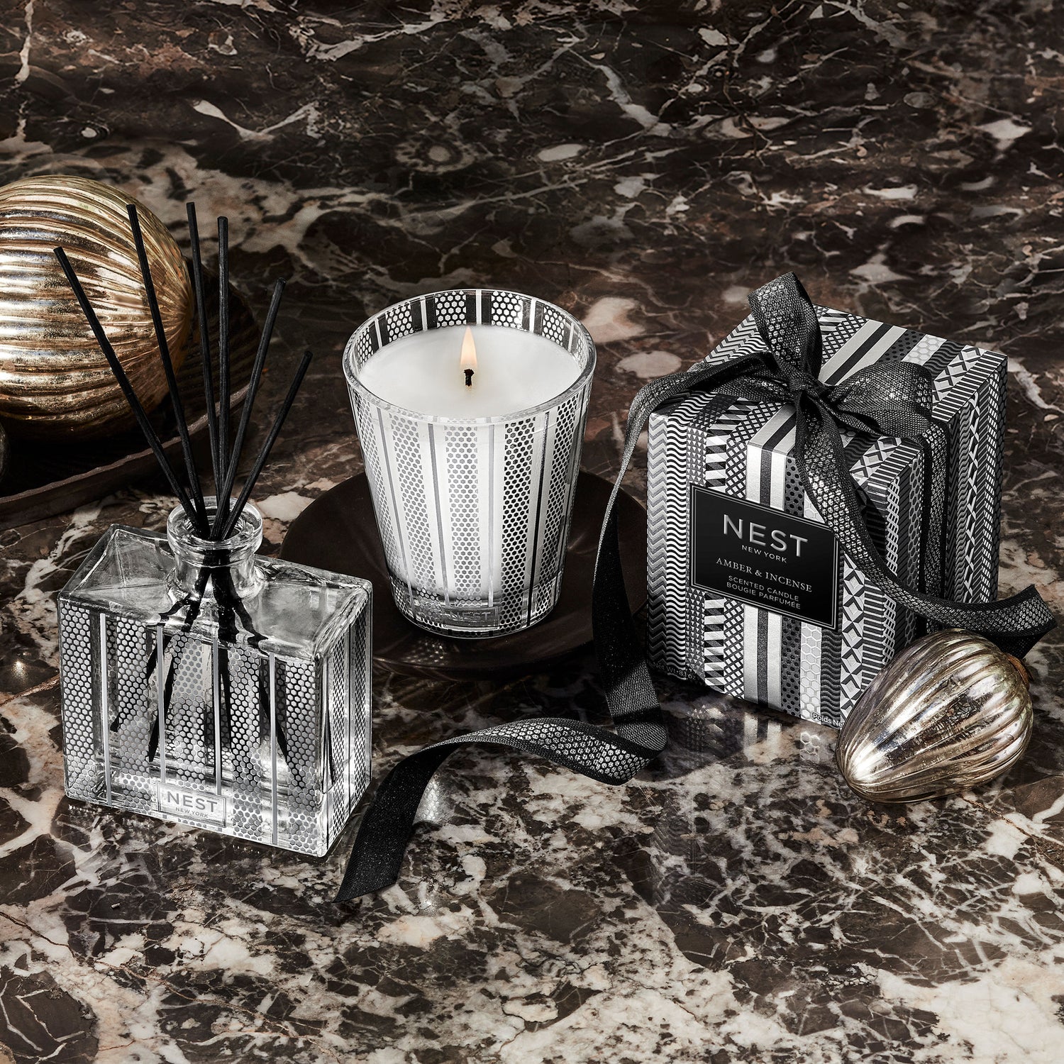 Lifestyle image of Nest Amber and Incense Candle (Limited Edition) variant: 8.1 oz (Classic)