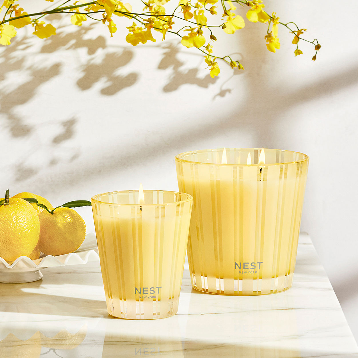 Lifestyle image of Nest Sunlit Yuzu and Neroli Candle variant: 8.1 oz (Classic)