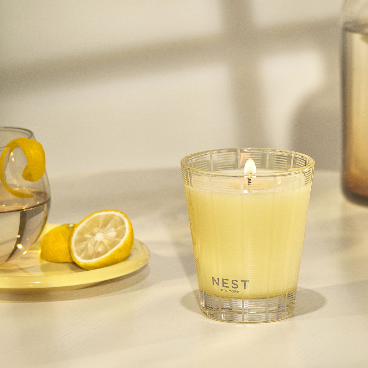 Lifestyle image of Nest Sunlit Yuzu & Neroli Candle variant: 8.1 oz (Classic)