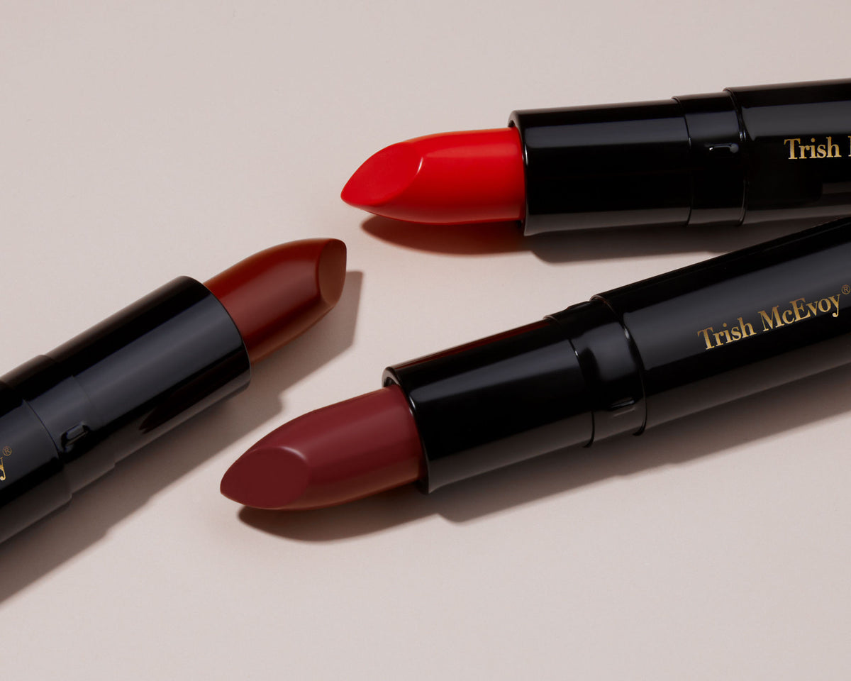 Three Easy Lip Color lipsticks in red, dark red, and deep burgundy, each presented in a luxurious black tube.