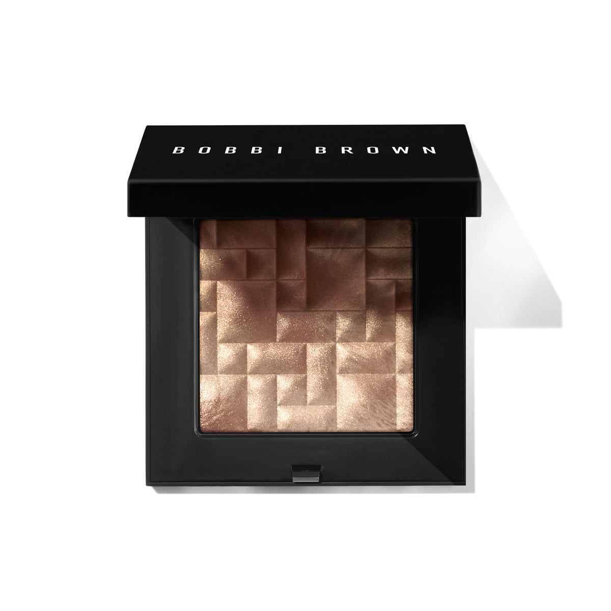 Open square compact containing Bobbi Brown Highlighting Powder, a shimmering, gold-toned highlighting powder with a high-impact, geometric, multi-faceted pressed surface that provides a radiant glow.