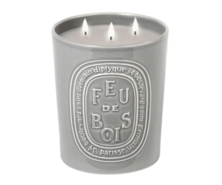 Gray three-wick Diptyque Feu de Bois (Wood Fire) candle with a white oval label, perfect for creating the cozy atmosphere of a burning wood fire.