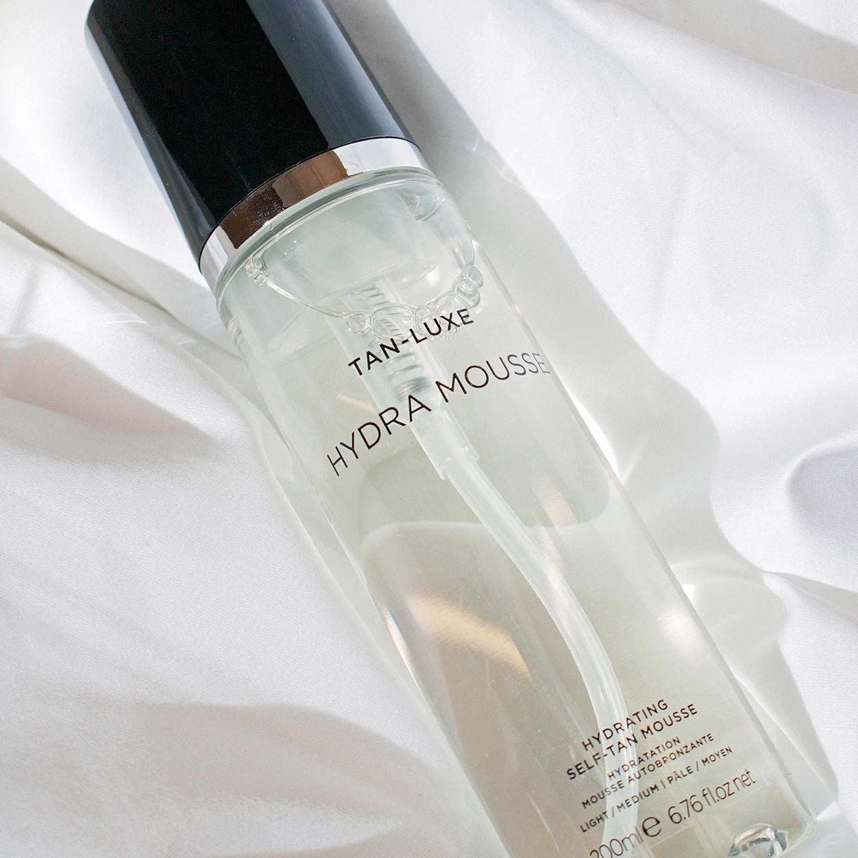 Lifestyle image of Tan-Luxe Hydra-Mousse Hydrating Self Tan Mousse variant: Medium/Dark