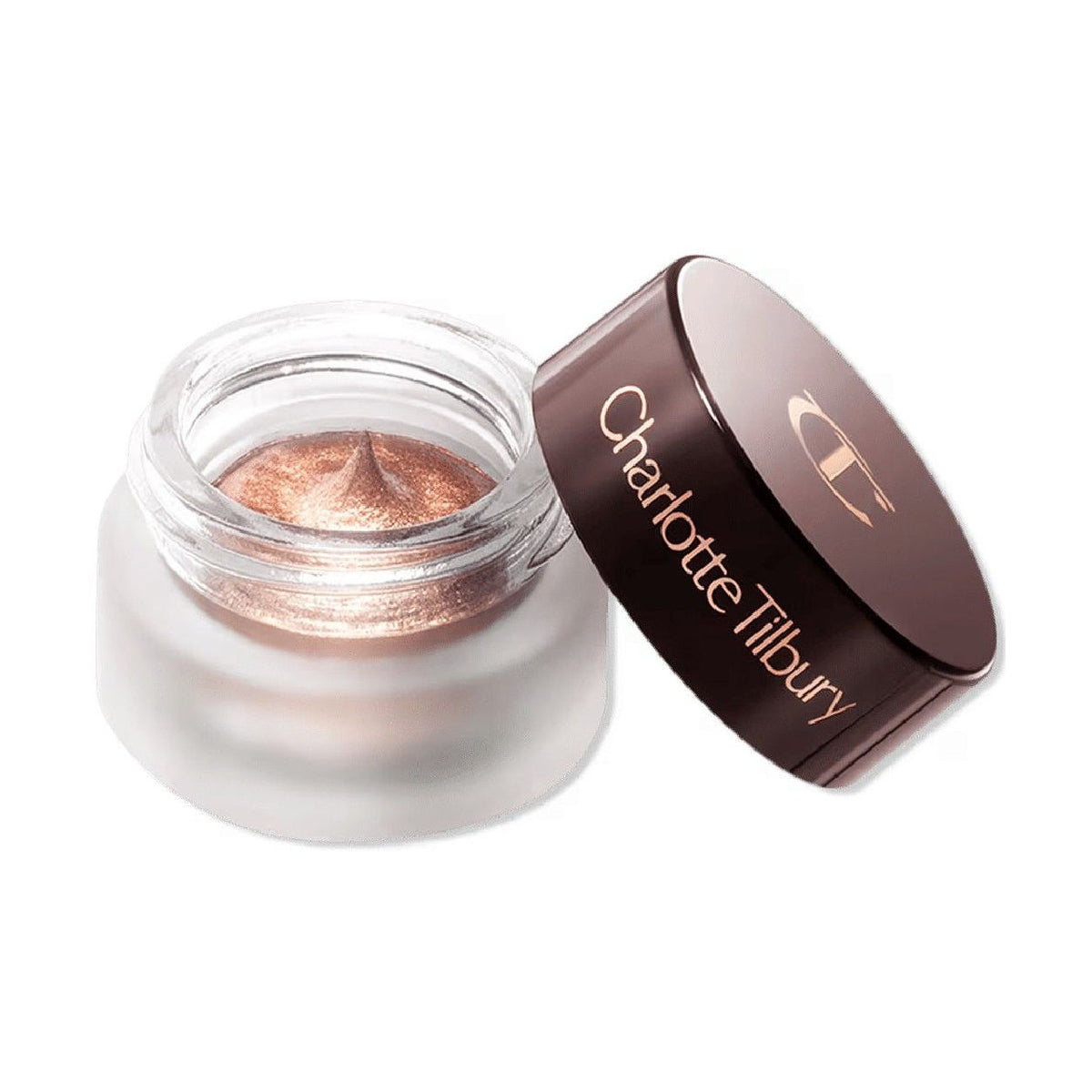 A small, round jar of Charlotte Tilbury Eyes To Mesmerise metallic copper cream eyeshadow with the lid resting beside it.