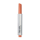 Lune+Aster Lip Glide, a twist-up stick of pale peach peptide lip balm in a silver metallic casing.