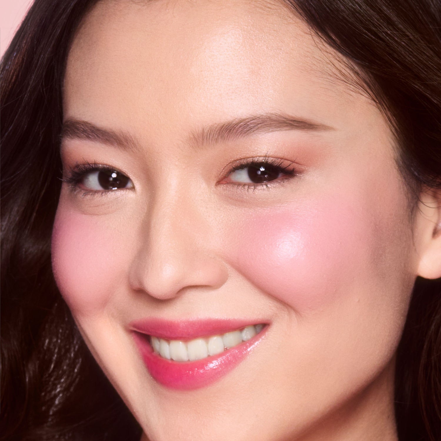 Model image of Charlotte Tilbury Unreal Lip + Cheek Glow Blush Stick with Hyaluronic Acid variant: Pretty Glow