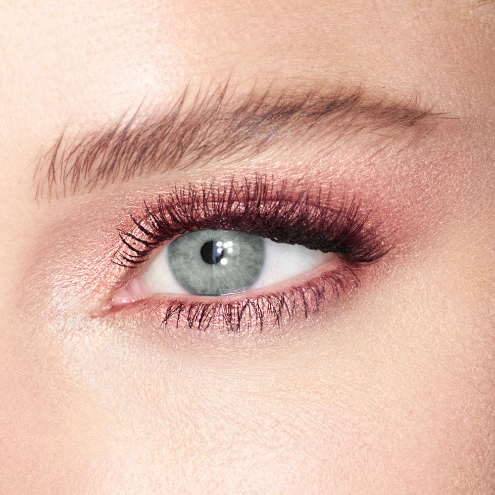 Close-up of an eye wearing shimmering copper Charlotte Tilbury Eyes To Mesmerise cream eyeshadow and mascara.