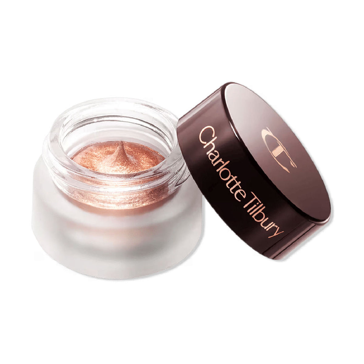 Open glass jar of Charlotte Tilbury Eyes To Mesmerise in metallic rose-gold cream eyeshadow with its dark brown lid resting beside it.