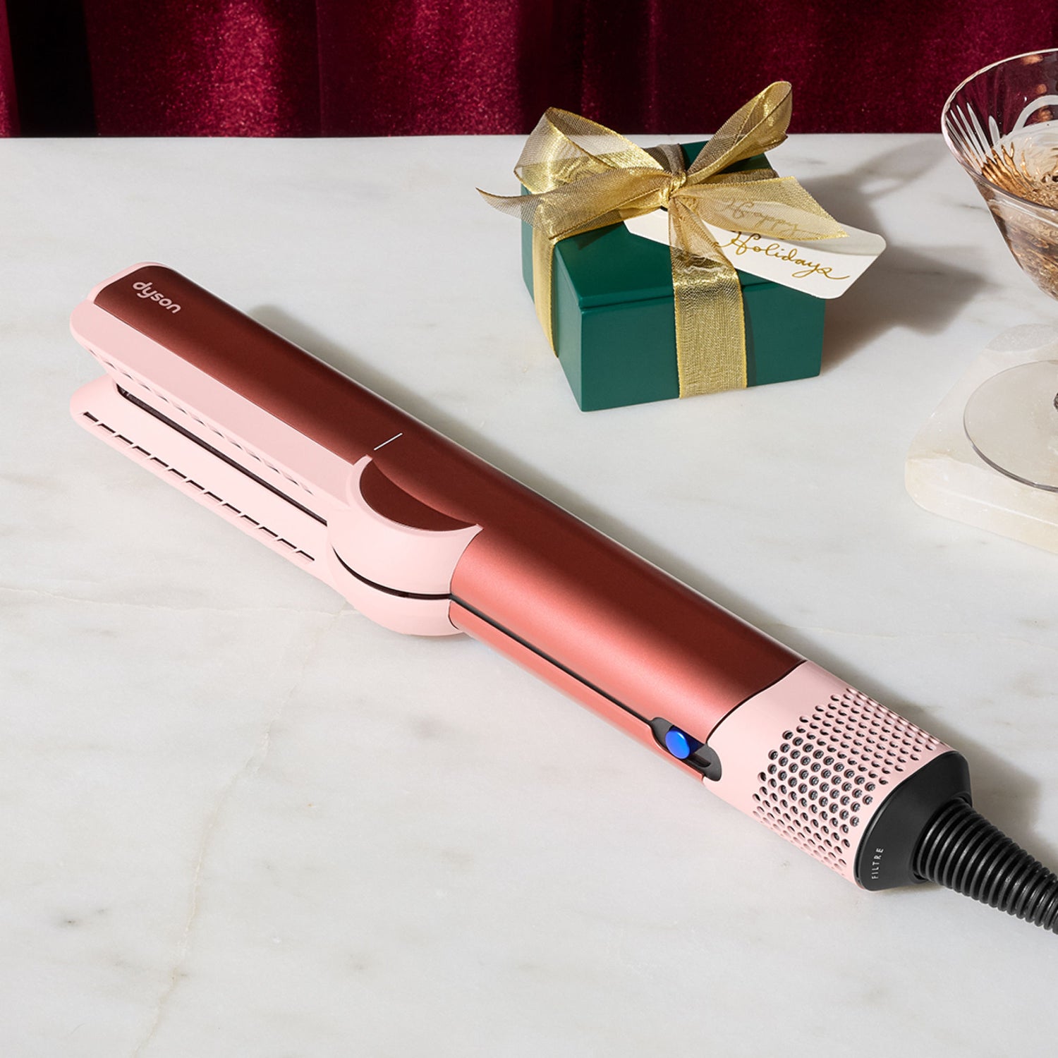 Lifestyle image of Dyson Airstrait Straightener variant: Strawberry Bronze and Blush Pink