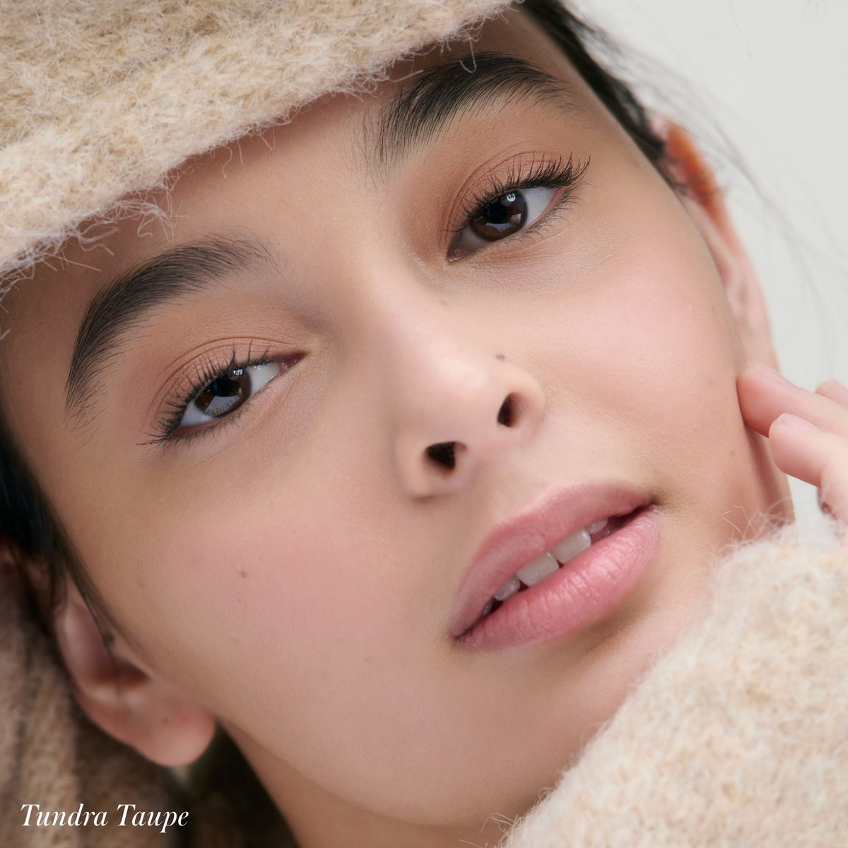 Close-up of a person wearing creaseproof, nourishing Cashmere Matte Eyelights in Tundra Taupe, with the text Tundra Taupe in the bottom left corner.