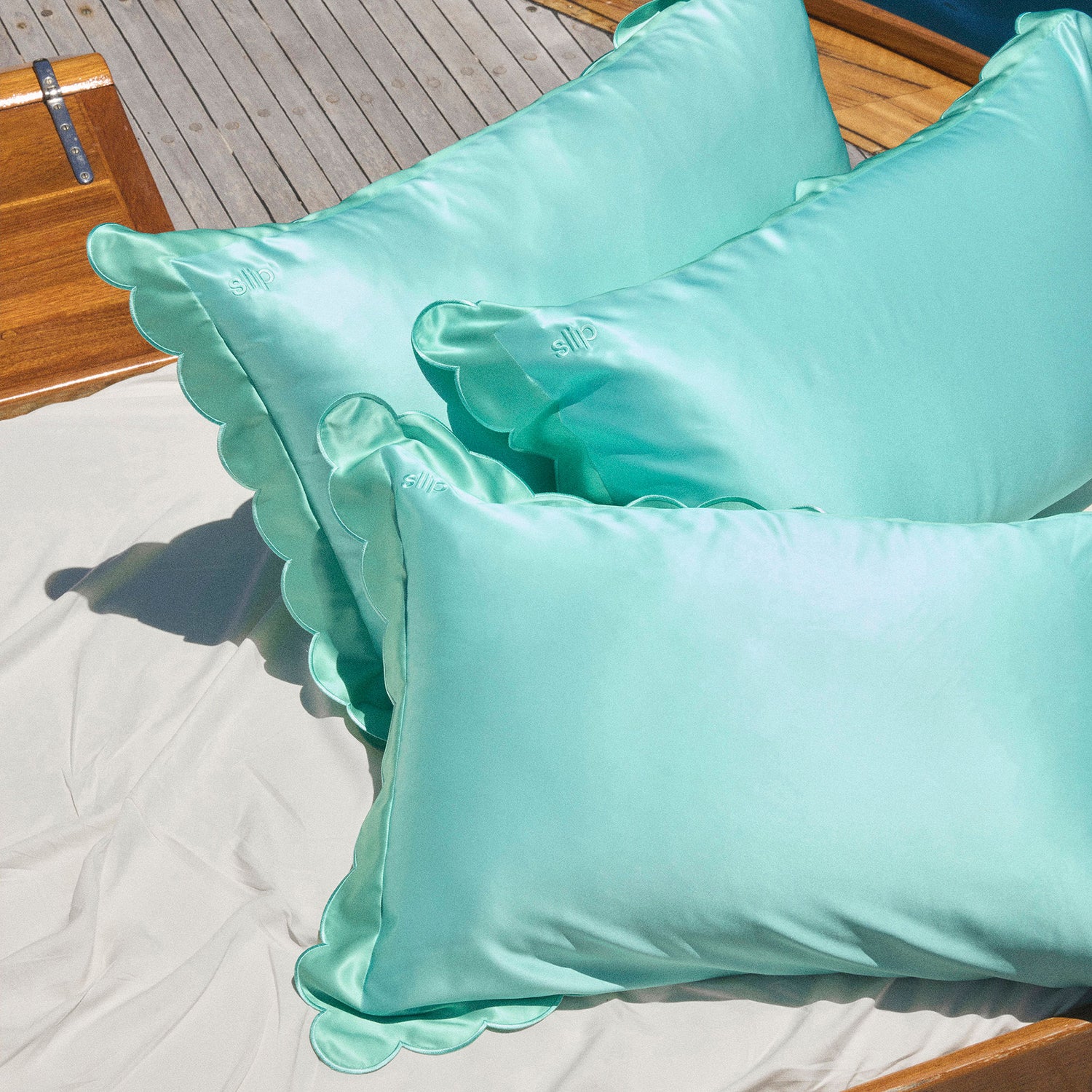 Lifestyle image of Slip Pure Silk Queen Pillowcase with Scalloped Edge variant: Turquoise (Limited Edition)