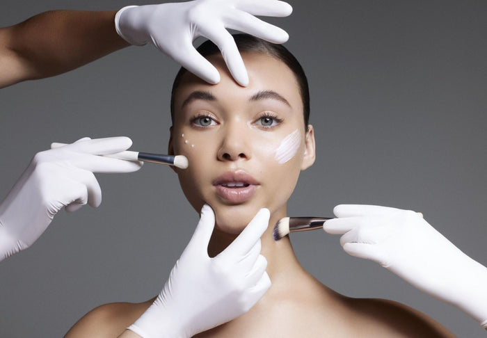 women with skincare being apply by multiple hands