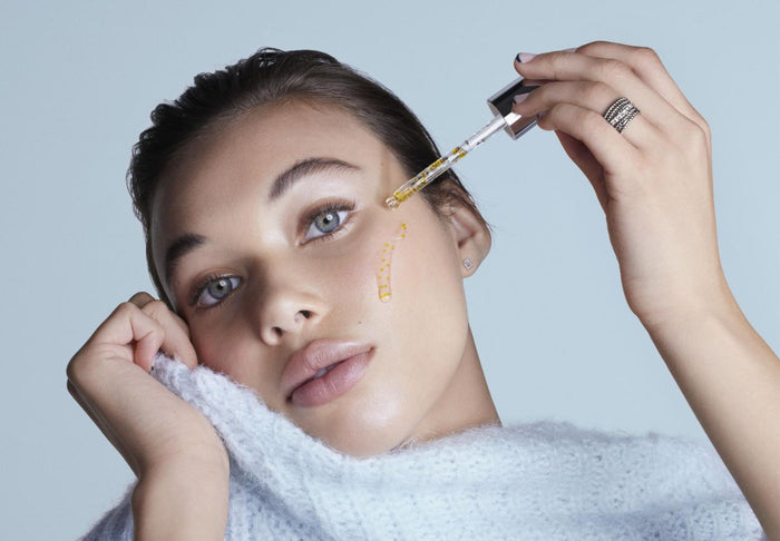 woman putting skincare on face