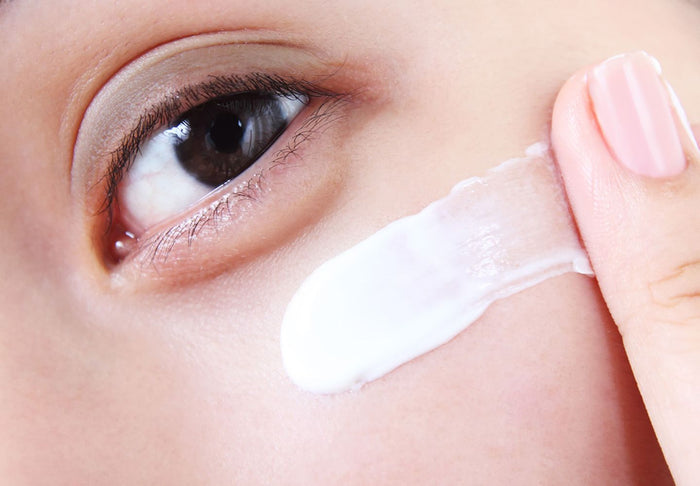 woman applying eye cream
