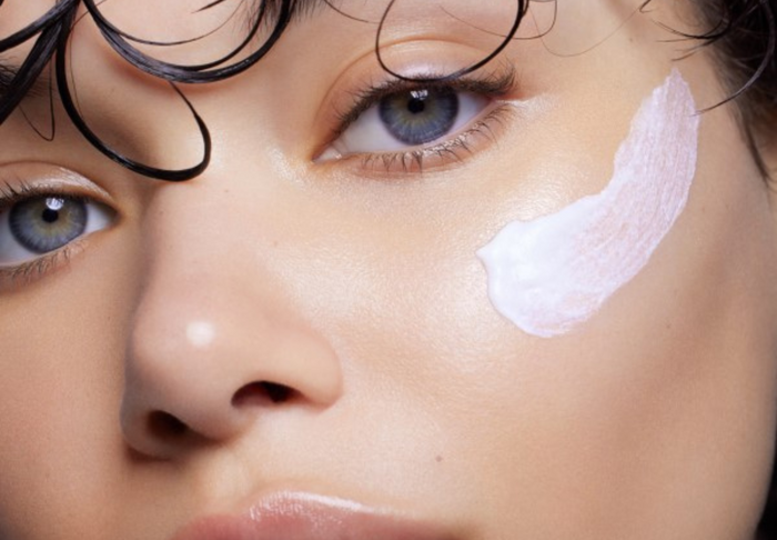 woman with sunblock swatched on her cheek