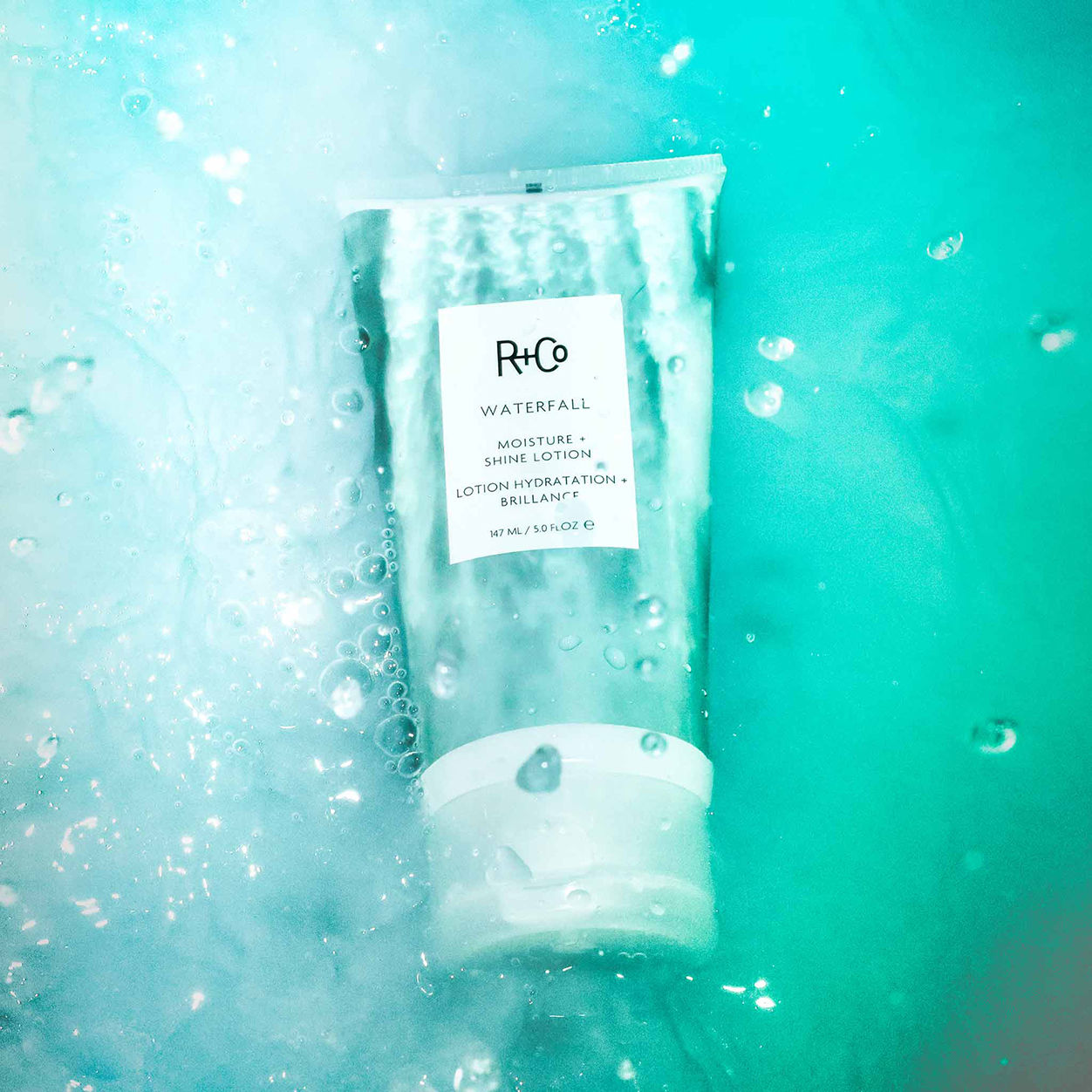 Lifestyle image of R+Co Waterfall Moisture and Shine Lotion